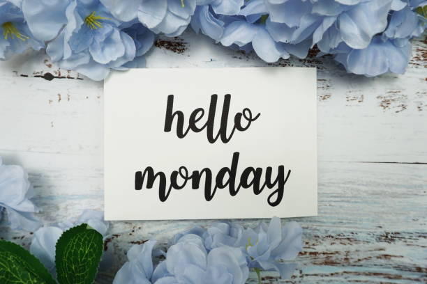 istock Hello Monday Card with Blooming flower on wooden background 1220690588