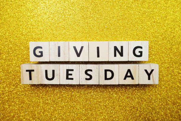 istock Giving Tuesday alphabet letter on yellow glitter background 1220691886