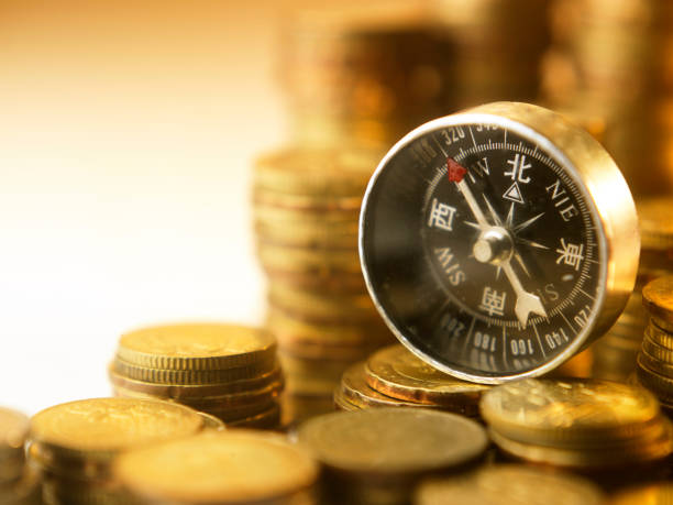 istock compass on many stacks of coins 1220692550