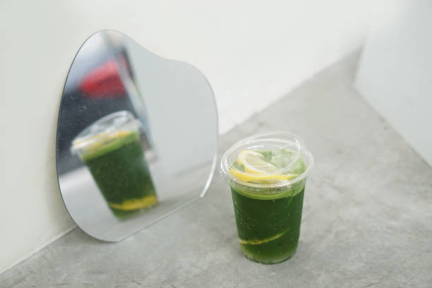 Iced matcha lemon soda - A plastic glass of green tea mixed with honey lemon soda on the table. Iced matcha lemon soda - A plastic glass of green tea mixed with honey lemon soda on the table, The perfect summer drink. green tea cocktail bar stock pictures, royalty-free photos & images