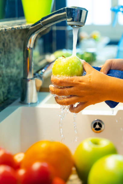 istock Rinsing and disinfecting fruit 1220697205