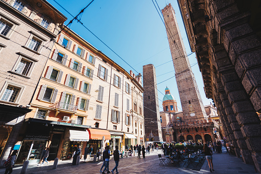 Via Rizzoli with Due torri towers and tourists in Bologna Italy