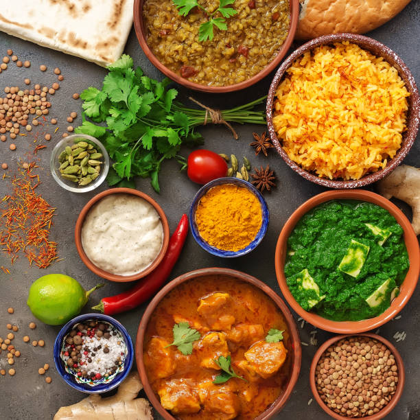 istock Assorted various Indian food on a dark rustic background. Traditional Indian dishes - Chicken tikka masala, palak paneer, saffron rice, lentil soup, pita bread and spices. Square photo.Top view. 1220698161
