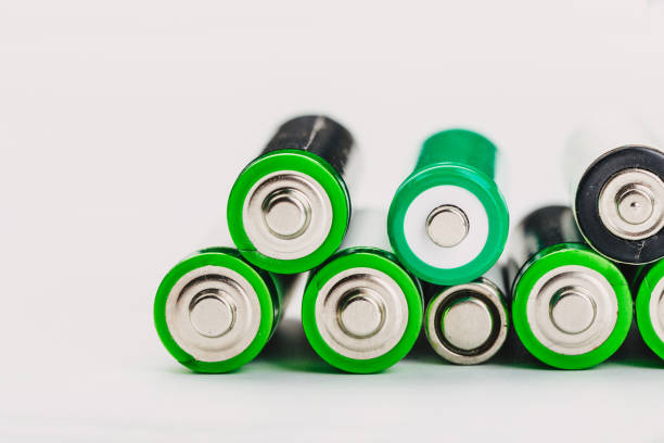 istock many new and used alkaline batteries type AA on a light background. 1220699151