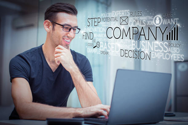 istock Happy handsome man working on laptop and virtual business text 1220699165