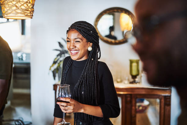 glimlachende vrouw die weg kijkt terwijl het hebben van wijn - drinking wine stockfoto's en -beelden