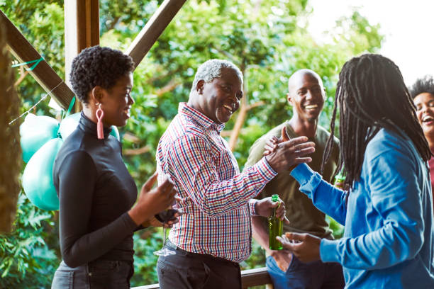 istock Friends looking at man giving high-five to father 1220700001
