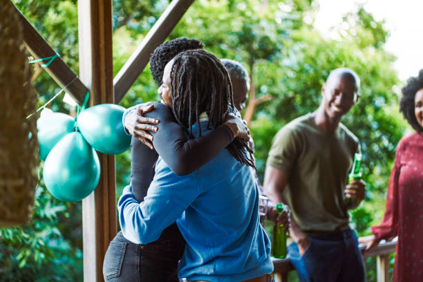 istock Friends embracing in balcony during birthday party 1220700047