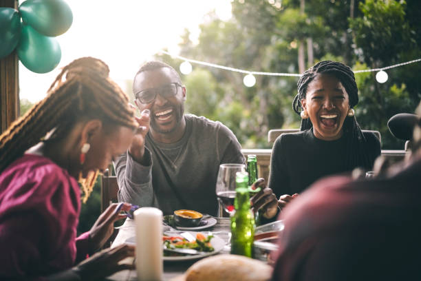 istock Happy friends talking while having meal at balcony 1220700099