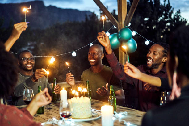 istock Happy friends enjoying with sparklers at night 1220700132