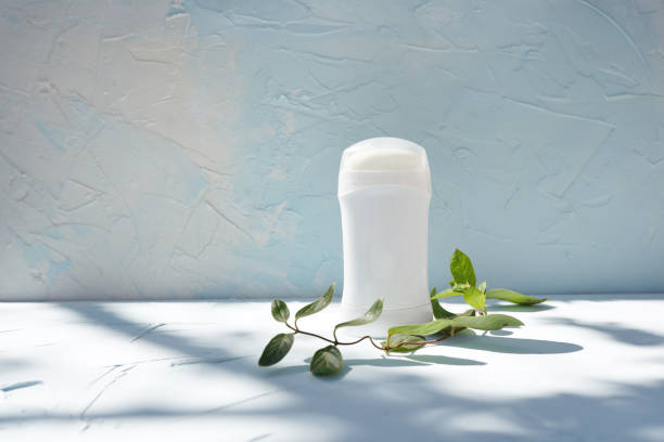 istock Stick deodorant and branch of tree at concrete textured wall 1220704331