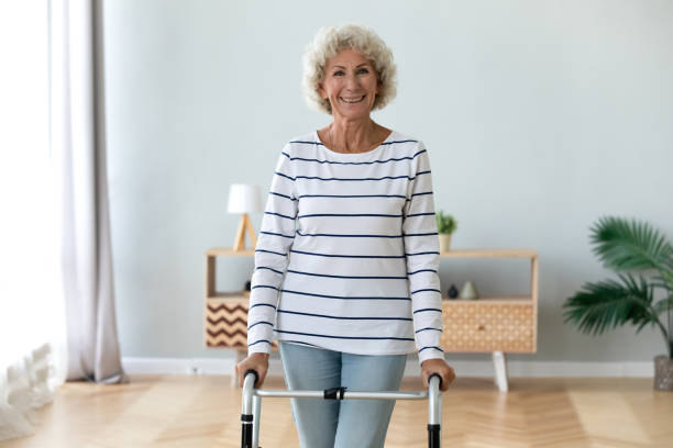 istock Portrait smiling disabled older woman standing with walker 1220704657