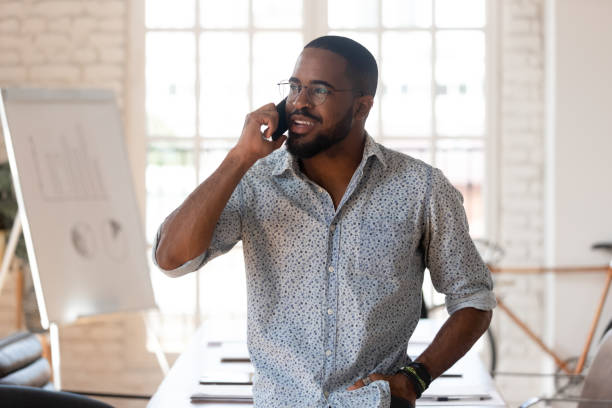 istock African businessman talking on phone inside of modern office 1220704708