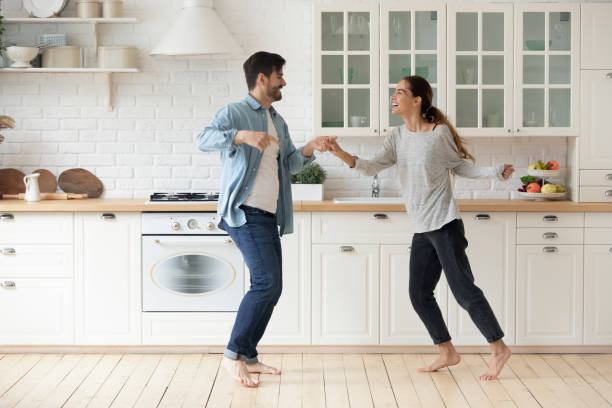 istock Happy active young couple husband and wife dancing in kitchen 1220704725