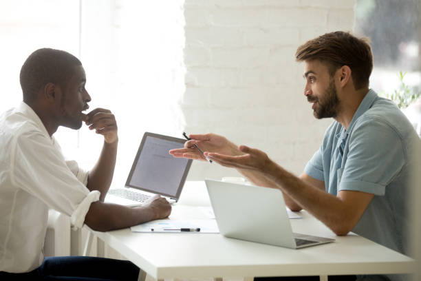 istock African-american and caucasian businessmen sharing ideas project plans at workplace 1220704740