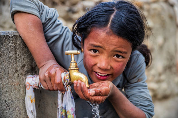 istock Nepalese girl drinking water, Upper Mustang, Nepal 1220704776