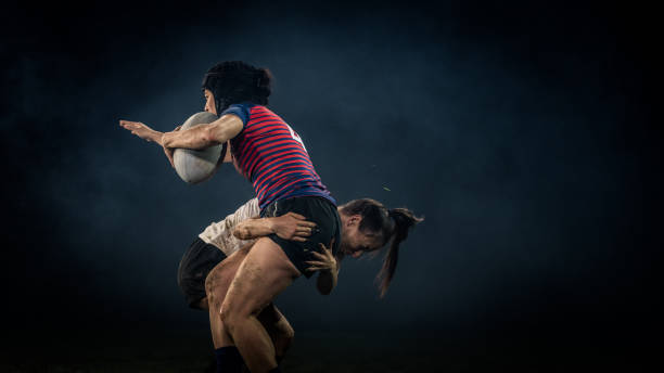 istock Female rugby player getting tackled 1220705344