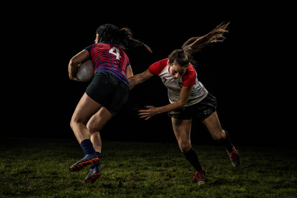 istock Female rugby player dodging a tackle 1220705346