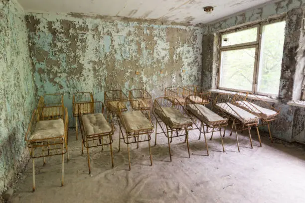 Cradles in abandoned hospital in ghost town Pripyat, Chernobyl zone, Ukraine