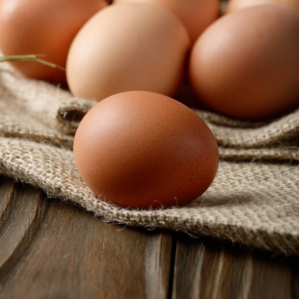 istock Fresh brown organic chicken eggs on wooden table and hemp burlap 1220706372