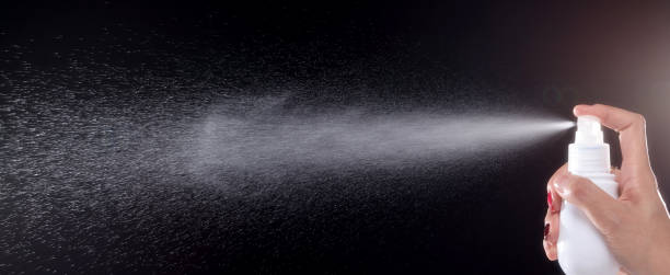 istock a spray of liquid in a black background. 1220707724
