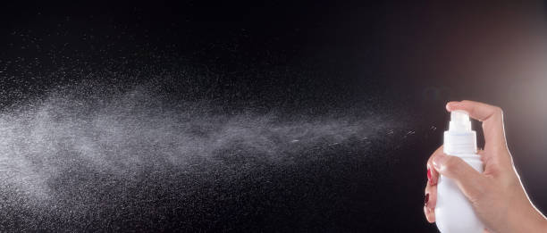 istock a spray of liquid in a black background. 1220707745