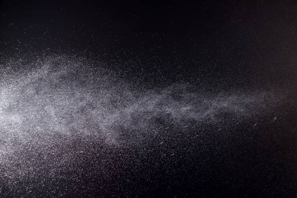 istock a spray of liquid in a black background. 1220707748