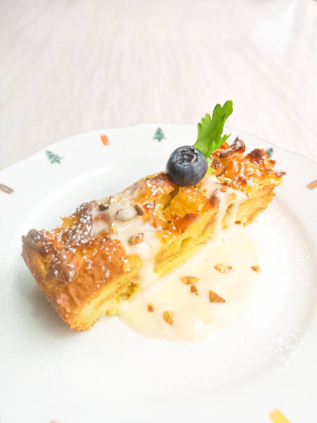 istock Blueberry bread pudding with hazelnut creamy on colourful play, Christmas breakfast 1220707993