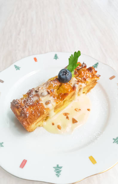 istock Blueberry bread pudding with hazelnut creamy on colourful play, Christmas breakfast 1220708224