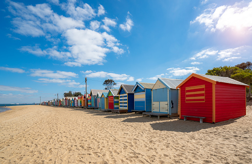 Beautiful Bathing houses on white sandy beach at Brighton beach in Melbourne, Australia.