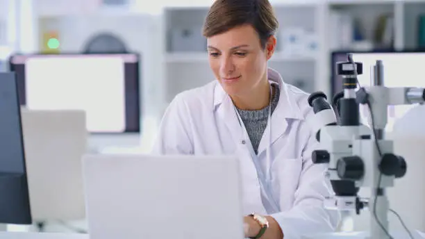 Shot of a scientist using a laptop in a lab