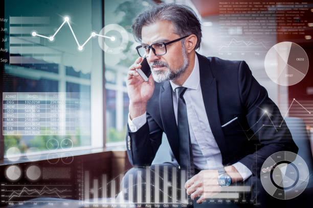 istock Tensed man talking on phone and virtual statistic graphics 1220710560