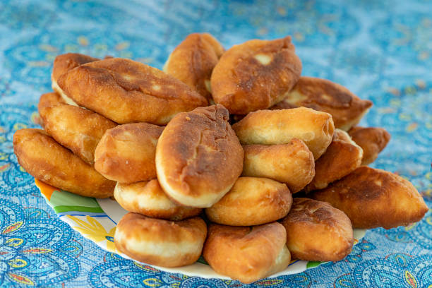 istock A lot of fried pies on a blue background. Selective focus. 1220710597