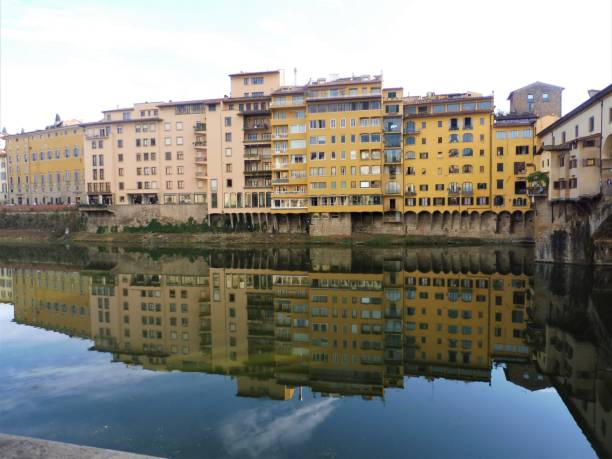 Buildings reflecting in Arno river, Italy