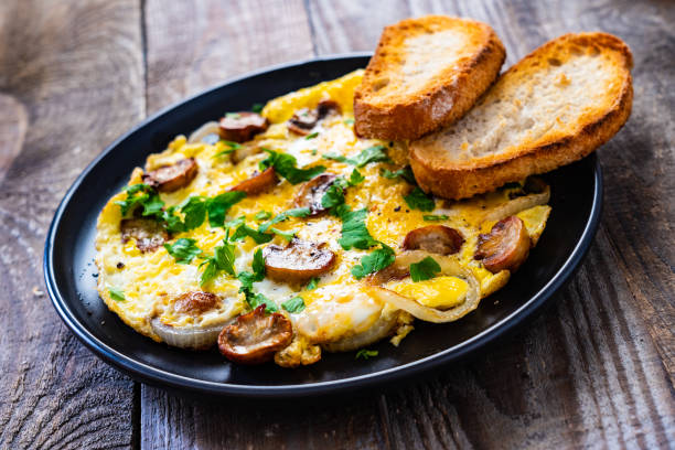 istock Omelette with mushrooms on wooden board 1220713776