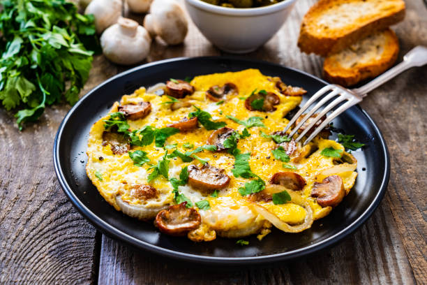 istock Omelette with mushrooms on wooden board 1220713895