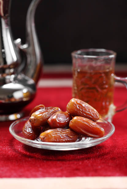 istock Dates fruit and Islamic Book Koran on carpet background, Islamic background in mosque 1220714002