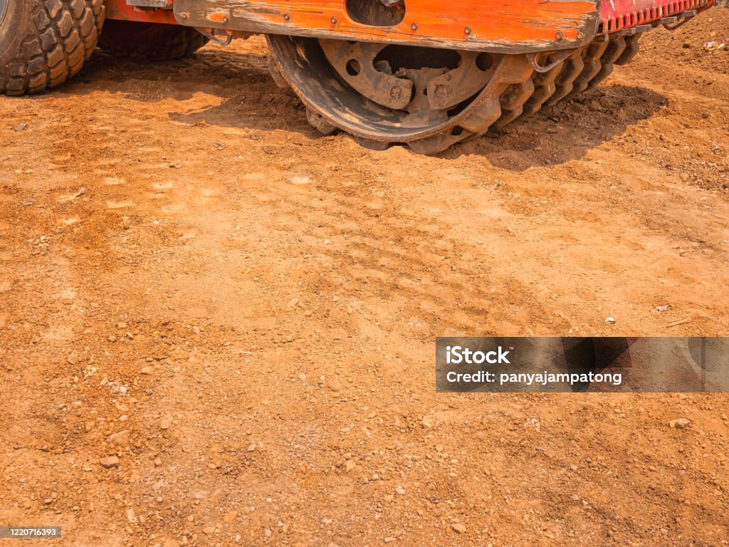 Road structure compacted with Vibratory Padfoot Compactor. Heavy machinery is working on road construction. Compactor Stock Photo