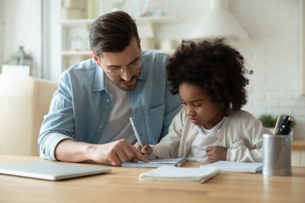 istock Caring dad help biracial daughter with homework at home 1220716904