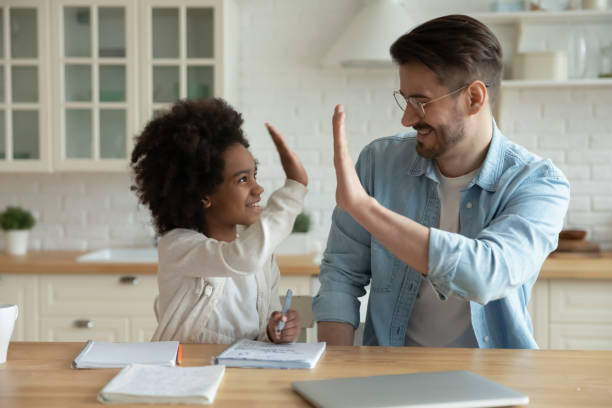 istock Caucasian father and ethnic daughter have fun studying together 1220716907