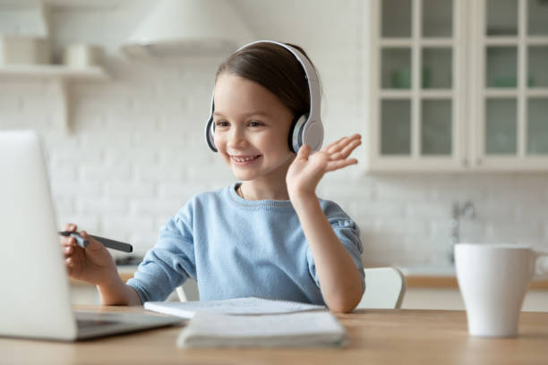 little girl have video call on laptop at home - child computer laptop little girls imagens e fotografias de stock