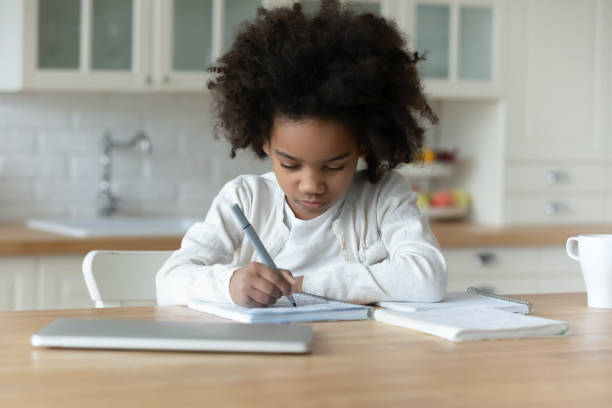 little biracial girl study at home on quarantine - child thinking writing little girls imagens e fotografias de stock