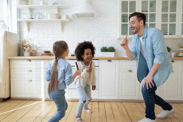 istock Overjoyed young dad and little daughter have fun in kitchen 1220716940