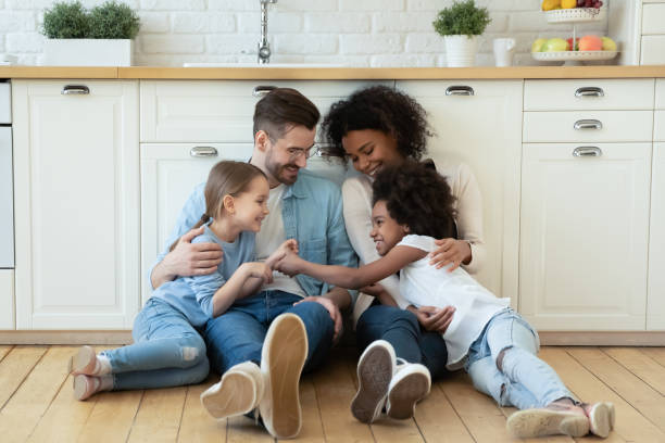 istock Happy multiethnic family with kids rest in kitchen 1220716943