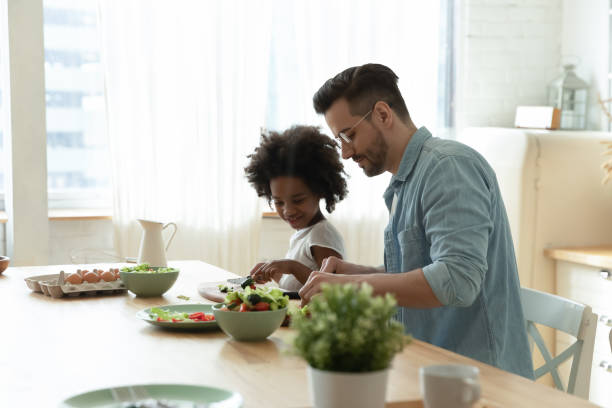 istock Young dad and biracial daughter prepare breakfast together 1220716985