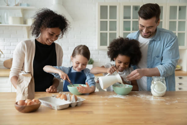 istock Happy multiethnic family with kids baking together 1220716991