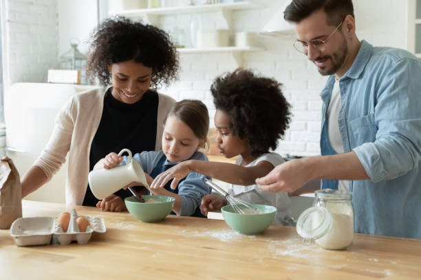 istock Happy multiethnic family with kids baking in kitchen together 1220716998