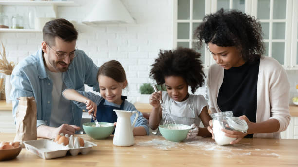 istock Multiethnic young family with kids baking in kitchen together 1220717003