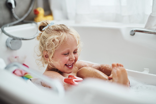 Cropped shot of an adorable little girl taking a bubble bath during her morning routine at home
