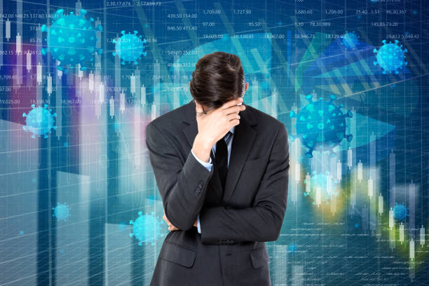 istock Businessman with head in hands during global financial crisis 1220717281